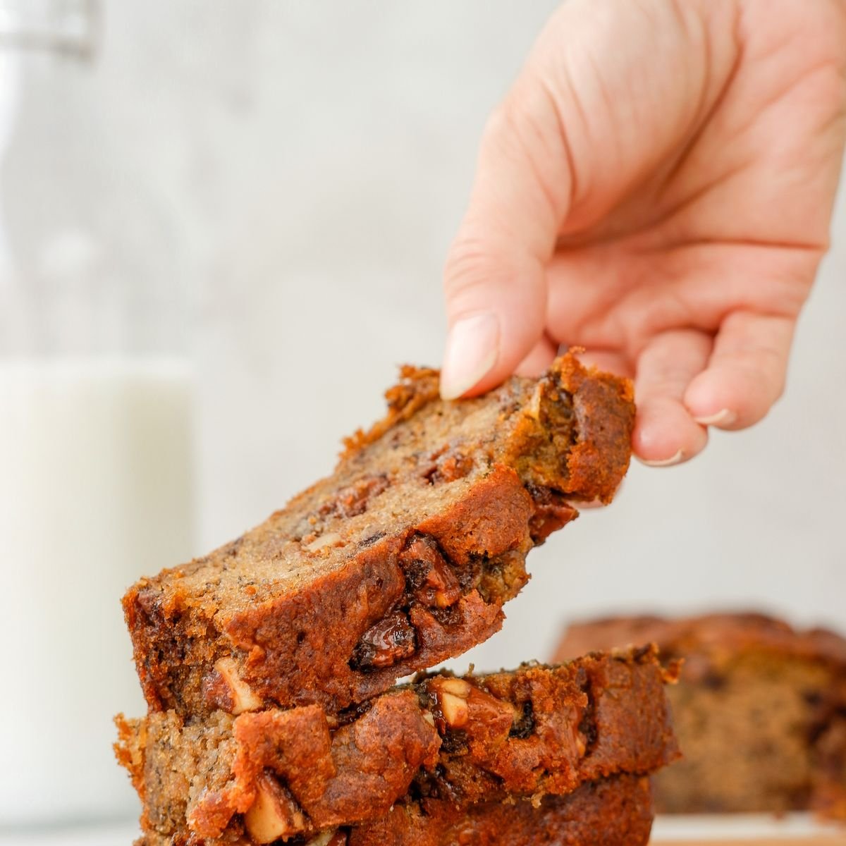 Hand holding a banana bread slice