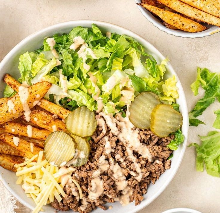 Burger Bowls 3 Deconstructed cheeseburger bowl with fries, pickles and burger sauce drizzle