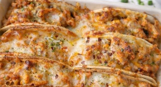 Chicken Bacon Ranch Tacos 3 Baking dish full of cheesy baked chicken bacon ranch tacos