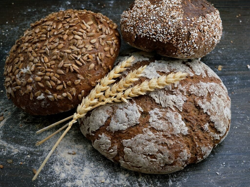 Sliced classic moist banana bread loaf with golden crust on a wooden board