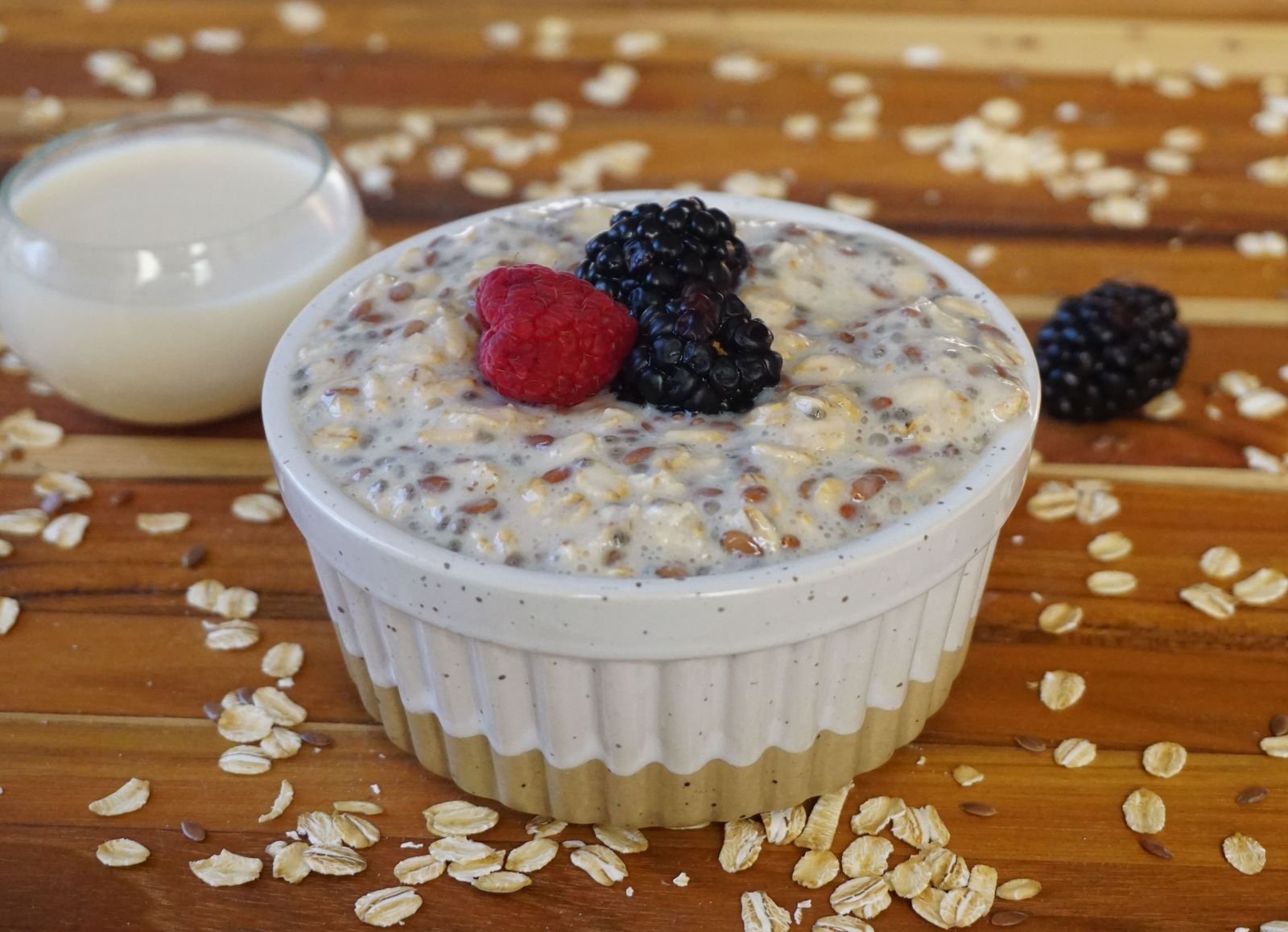 Classic Overnight Oats (Creamy, Make-Ahead, Ready in the Morning) 2 A bowl of creamy overnight oats with chia seeds, raspberries and blackberries, with a glass of milk beside it