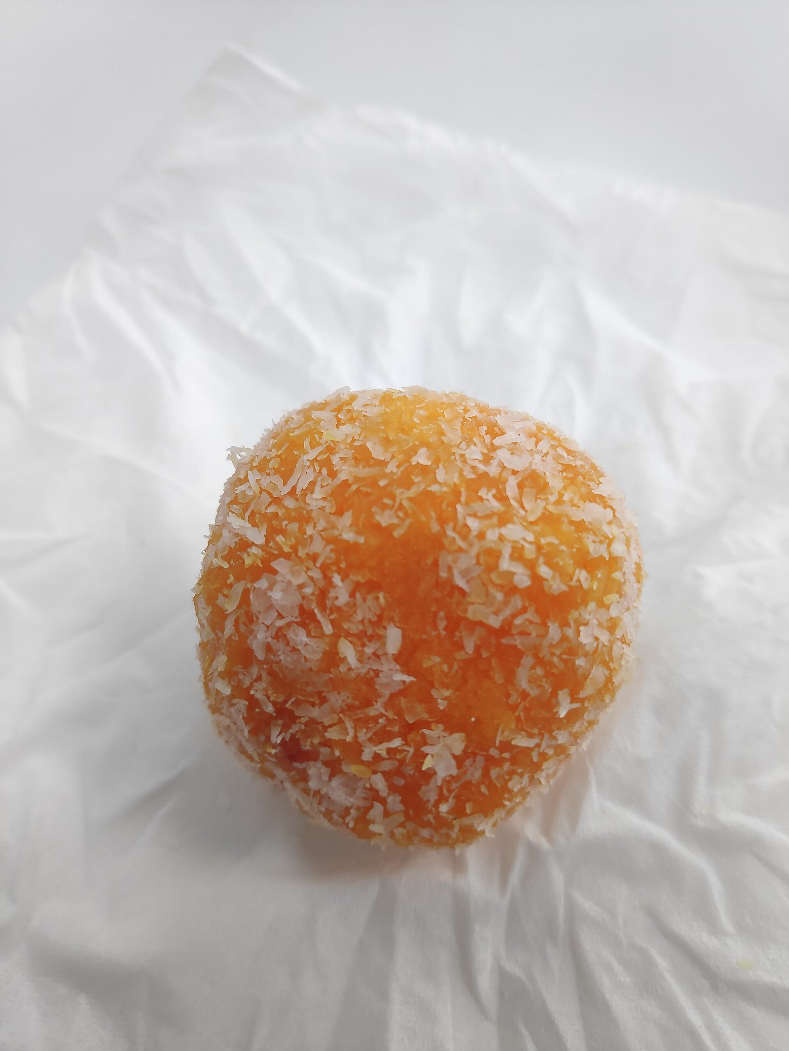 Coconut Ladoo Energy Bites (No-Bake, 5-Ingredient, Cardamom-Scented) 2 Close-up of a single coconut-coated ladoo ball.