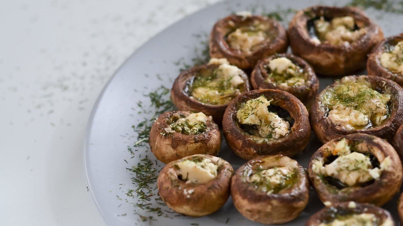 Mushroom caps filled with green goddess filling before baking