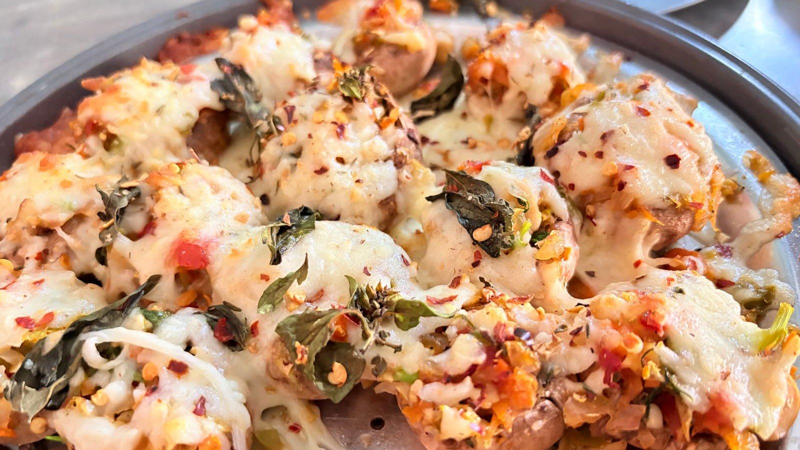 Close-up of baked green goddess stuffed mushrooms with golden panko tops