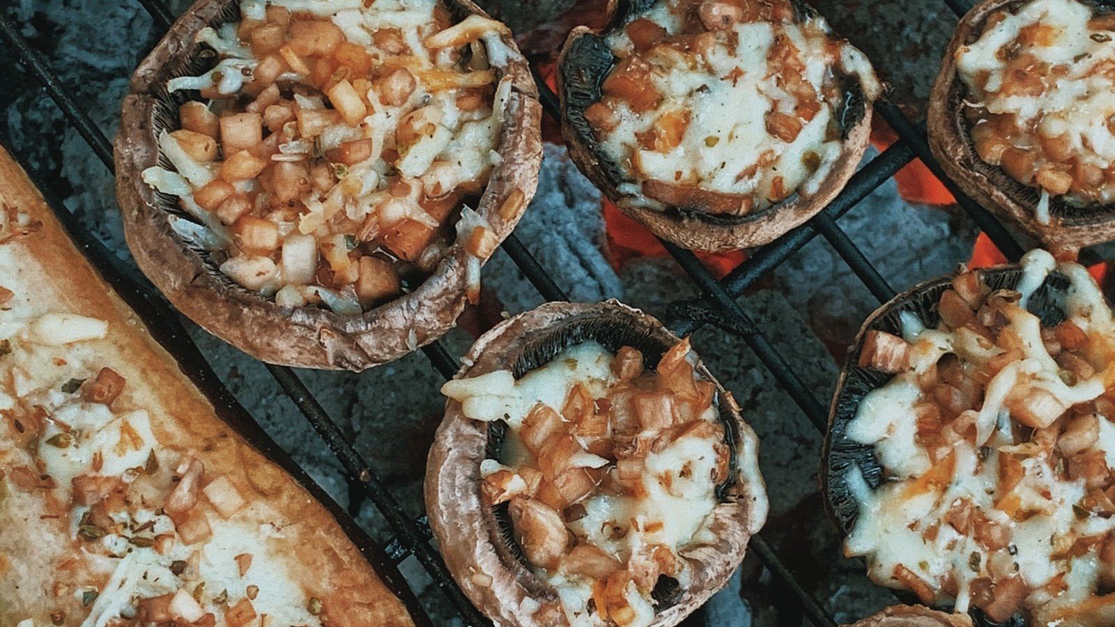 Green goddess stuffed mushrooms arranged on a dark Halloween platter