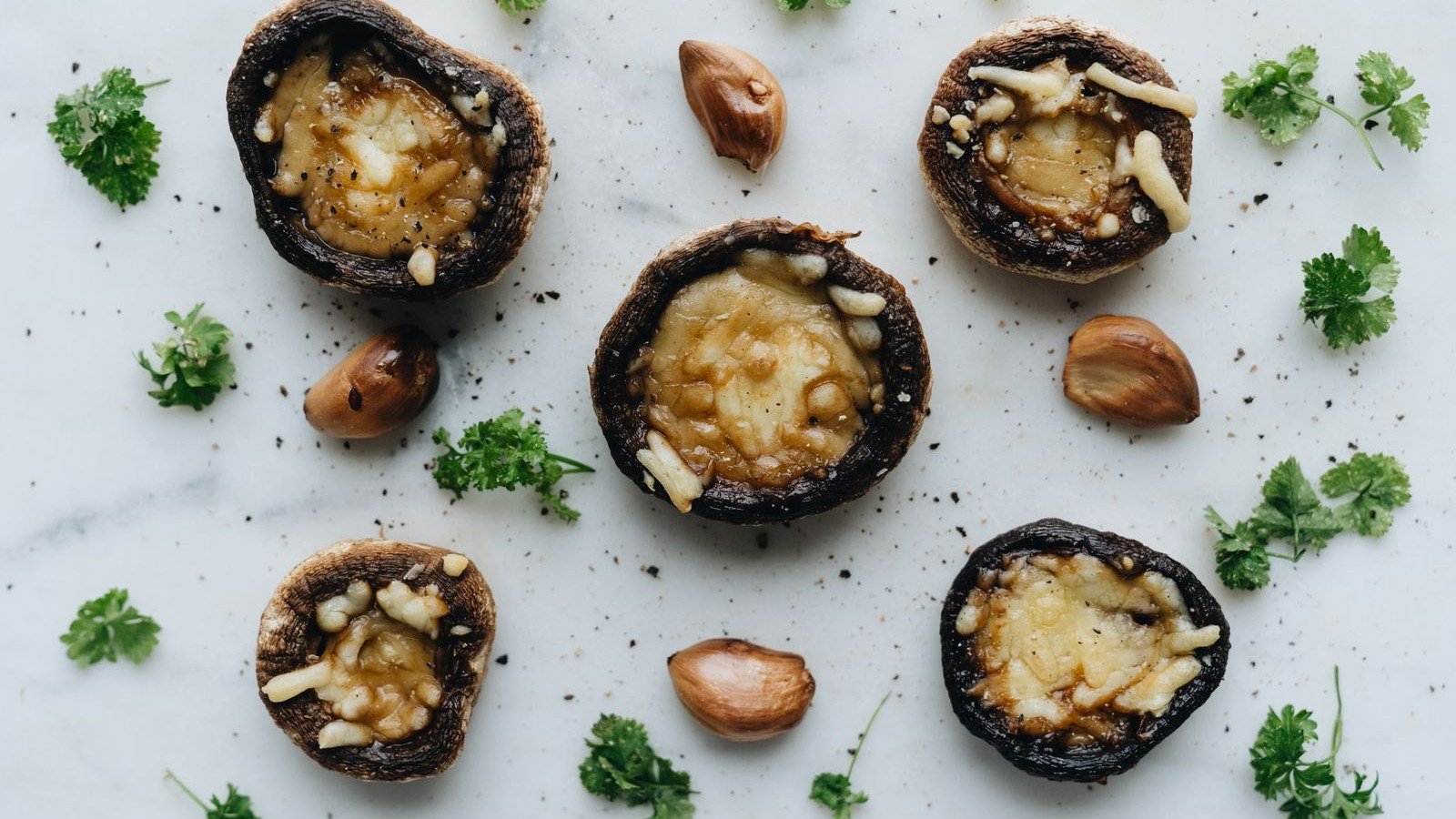 A tray of golden baked green goddess stuffed mushrooms ready to serve