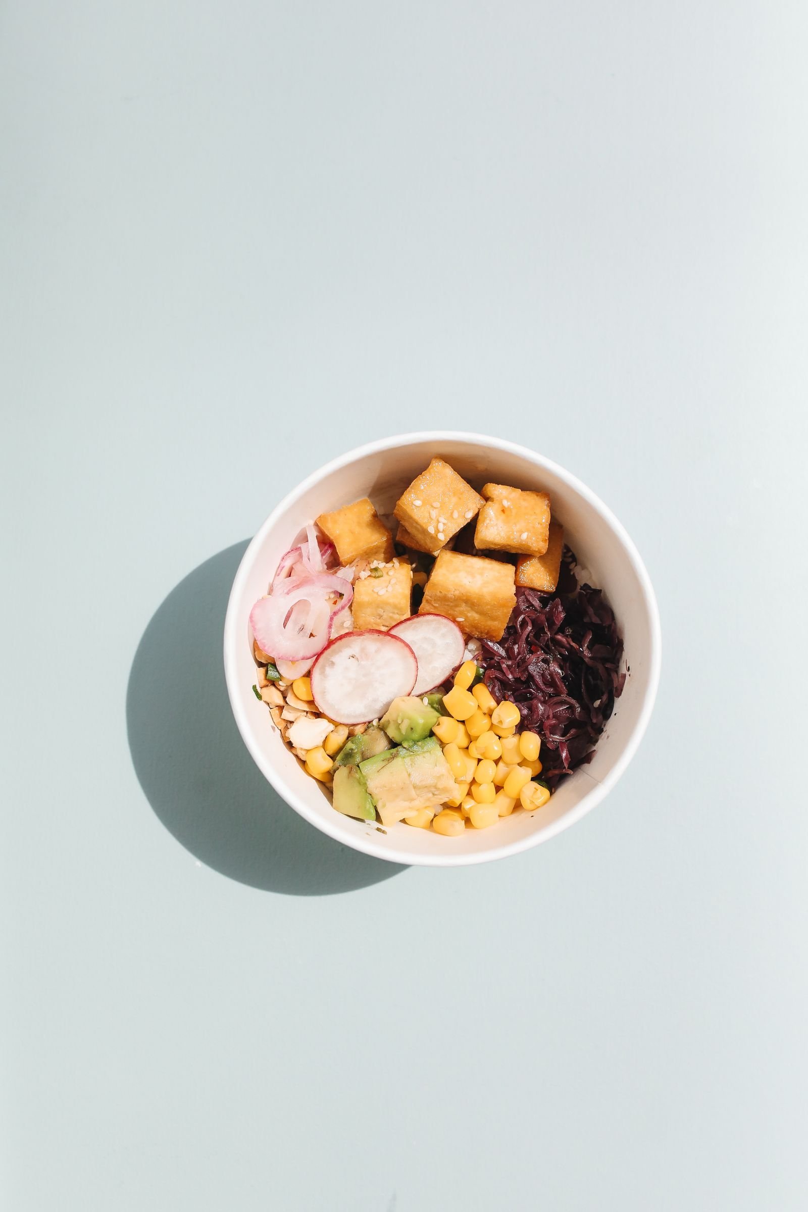 Crispy Tofu Bowls (Golden Tofu, Crunchy Veggies, Spicy Mayo) 2 Overhead bowl of crispy tofu with avocado, corn, radish, pickled onion, and cabbage