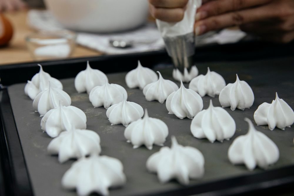 Piping ghost meringue cookies