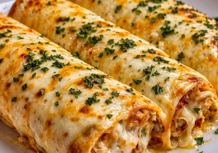 Healthy Chicken Enchiladas 3 Close-up of cheesy healthy chicken enchiladas showing the shredded chicken filling