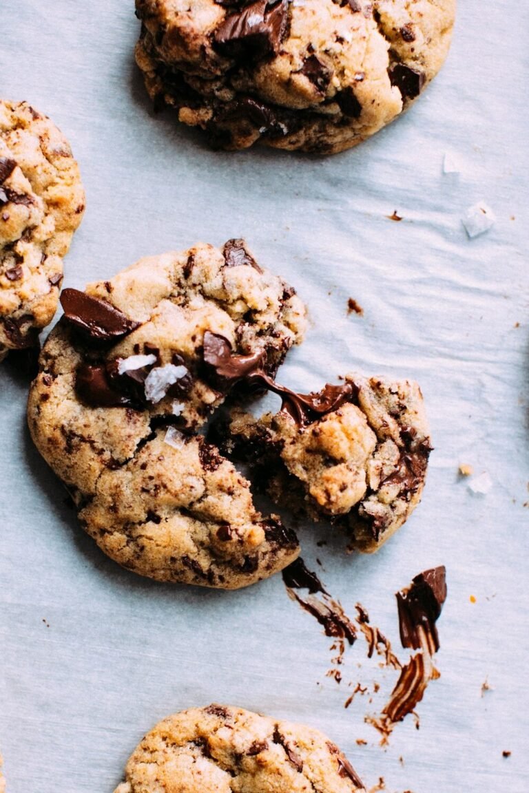 Warm gooey scoopable chocolate chip cookie pulled apart with melted chocolate and sea salt