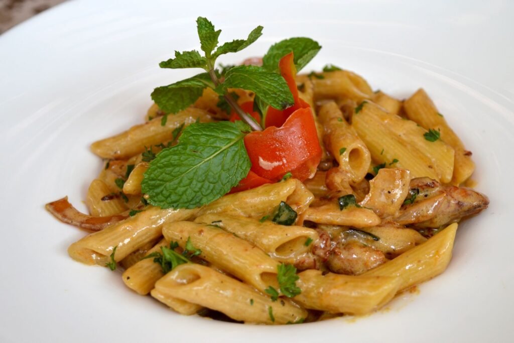 Creamy Marry Me Chicken Pasta (The 30-Minute Weeknight Dinner) 2 Creamy marry me chicken pasta with chicken, tomatoes and fresh herbs on a white plate