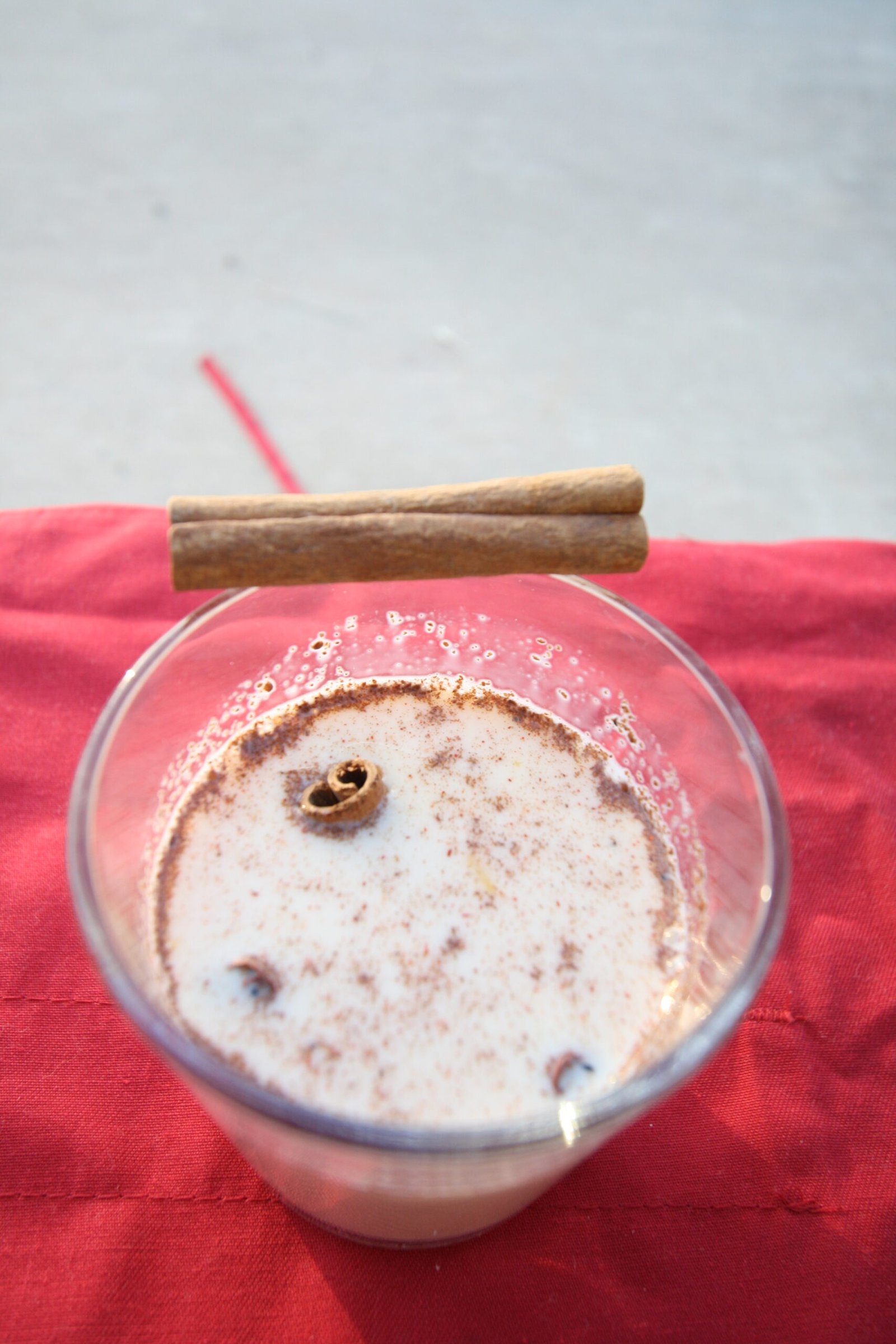 Homemade Eggnog (Thick, Creamy, Gently Spiced for Christmas) 2 A glass of creamy homemade eggnog dusted with cinnamon and nutmeg beside cinnamon sticks
