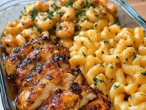 Sliced honey garlic butter chicken served with mac and cheese in a glass dish