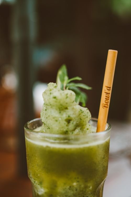 Frosty green monster shake with a bamboo straw
