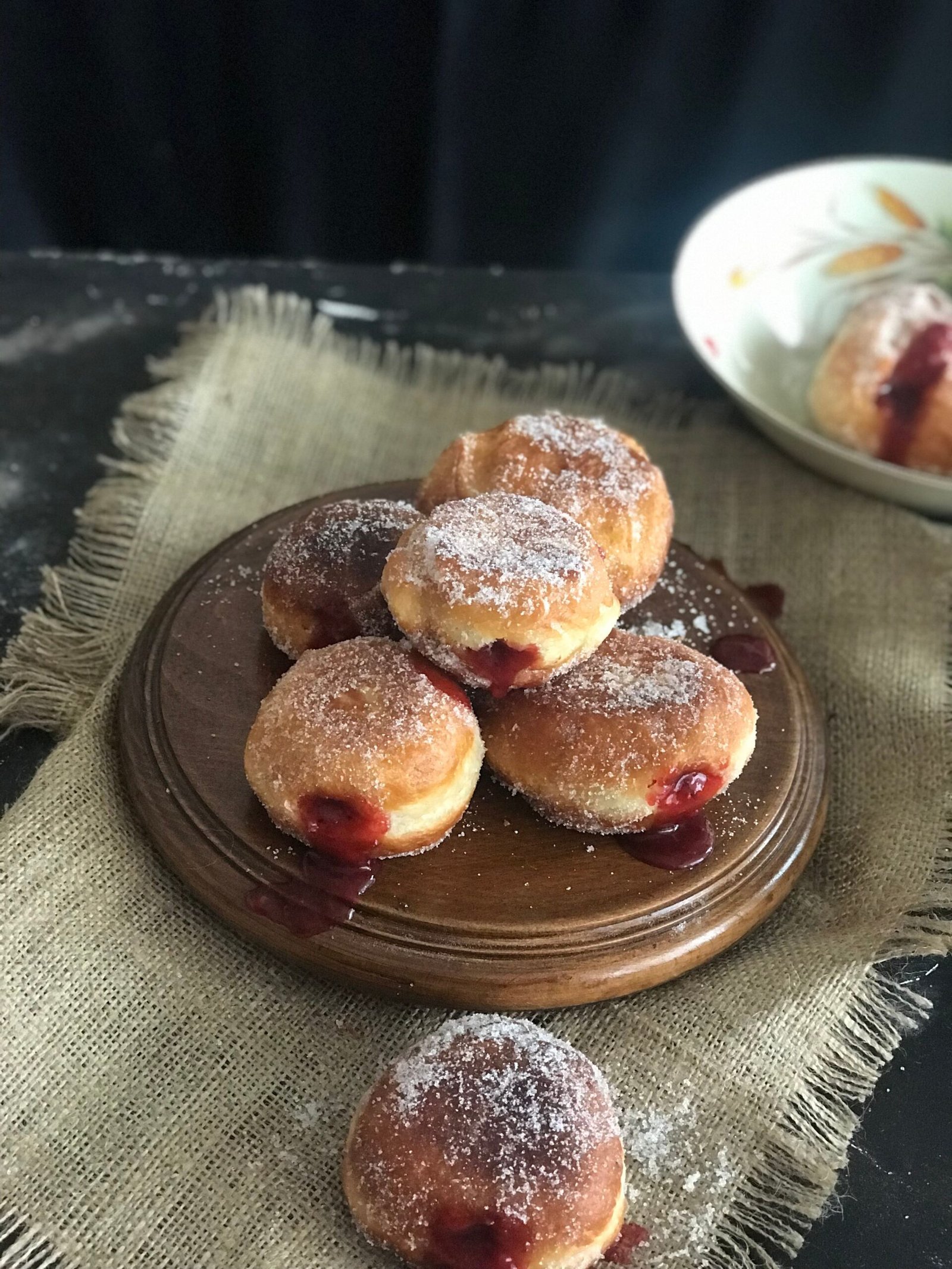 Sugar-dusted vampire bite donuts cooling on a rack
