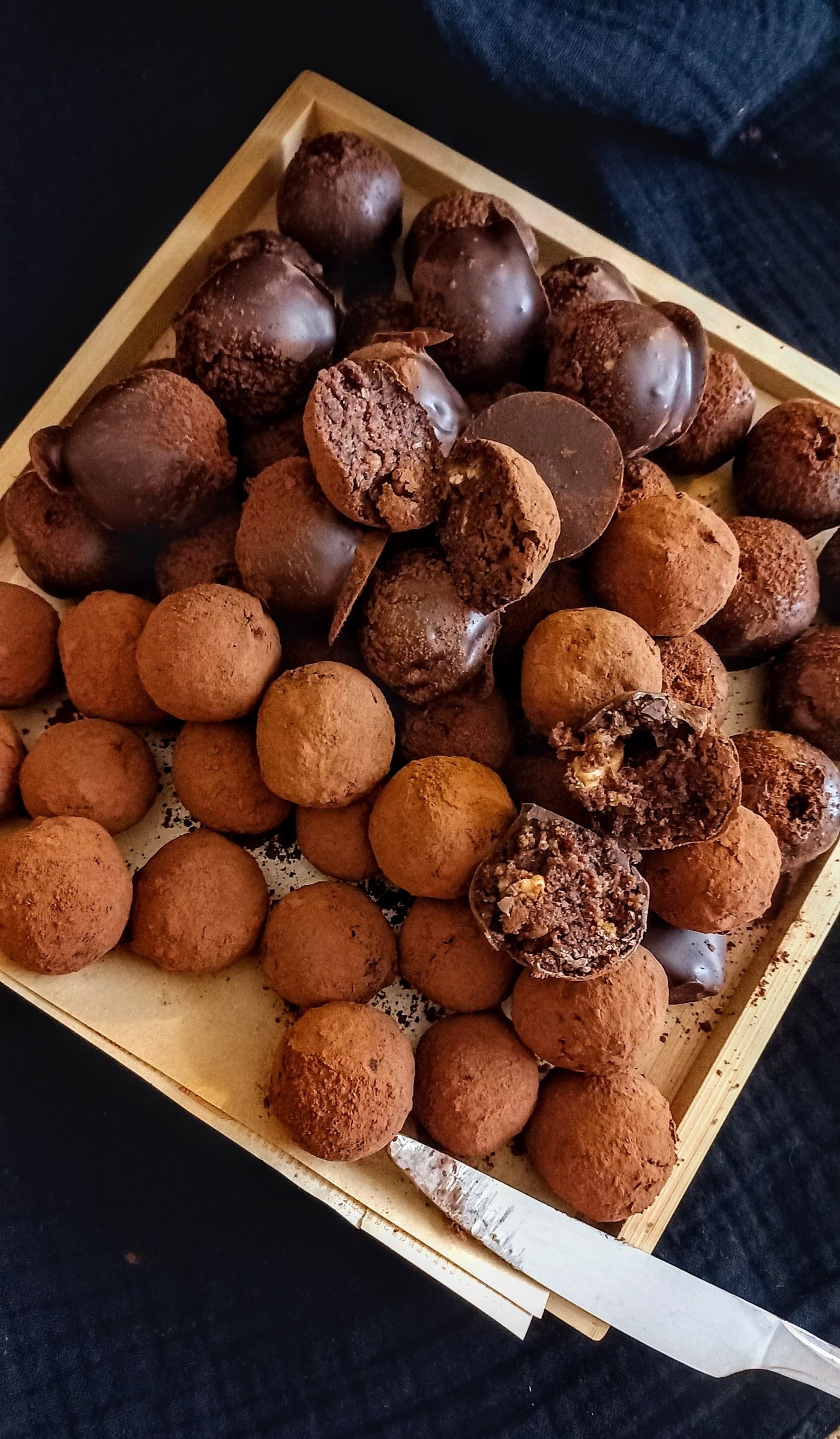 Decorating chocolate truffles with orange drizzle