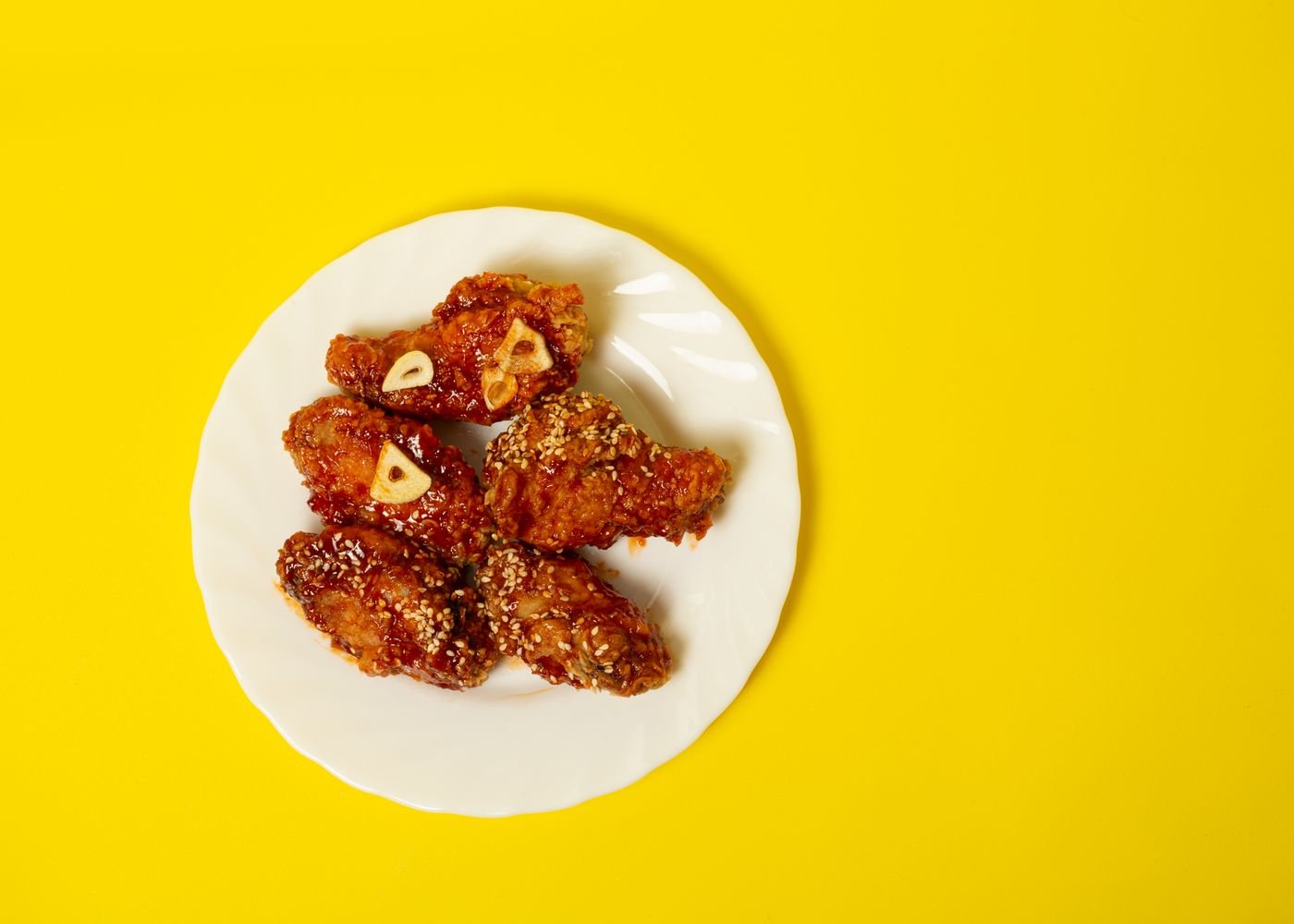 Crispy Air Fryer Bat Wings (The 25-Minute Halloween Party Wings) 5 Glazed bat wings being tossed in sauce
