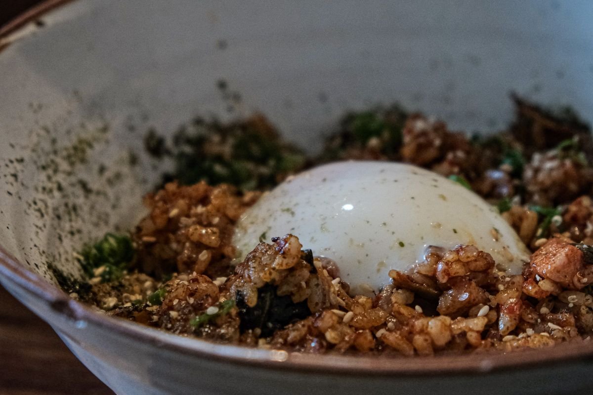 Close-up of golden chicken fried rice with peas and carrots