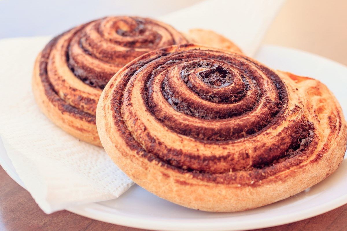 Soft & Fluffy Cinnamon Rolls (The 2-Hour Bakery-Style Recipe) 4 Two cinnamon swirl rolls on a white plate