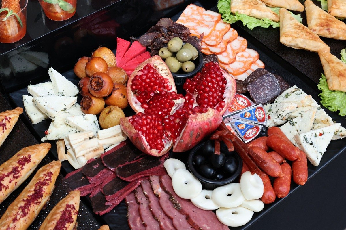 Spooky Halloween Charcuterie Board (The 25-Minute No-Bake Party Board) 4 Brie mummy with candy eyes surrounded by grapes and blackberries on the Halloween charcuterie board