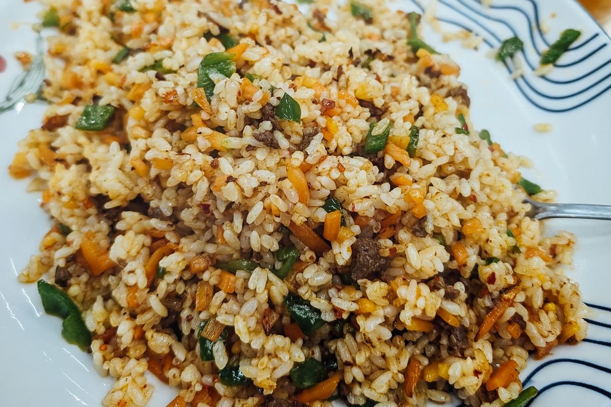 Bowl of chicken fried rice with green onions