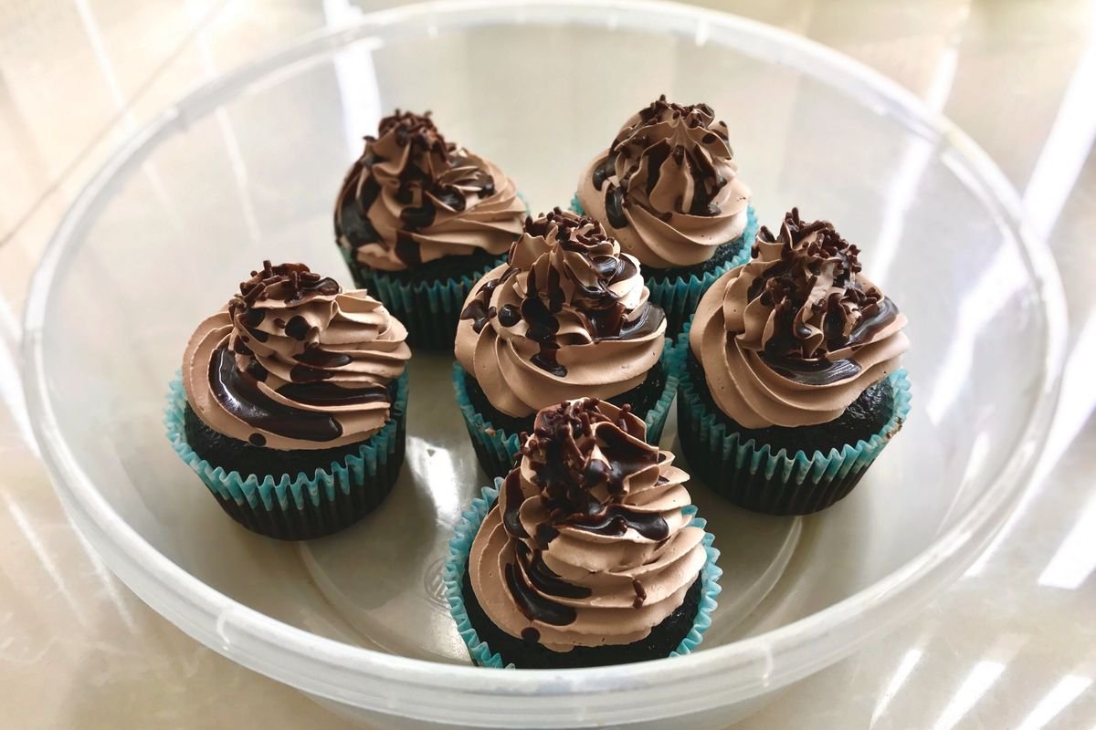Death by Chocolate Cupcakes (The Ultra-Fudgy 40-Minute Triple-Chocolate Recipe) 5 Six frosted death by chocolate cupcakes in a clear container ready to serve