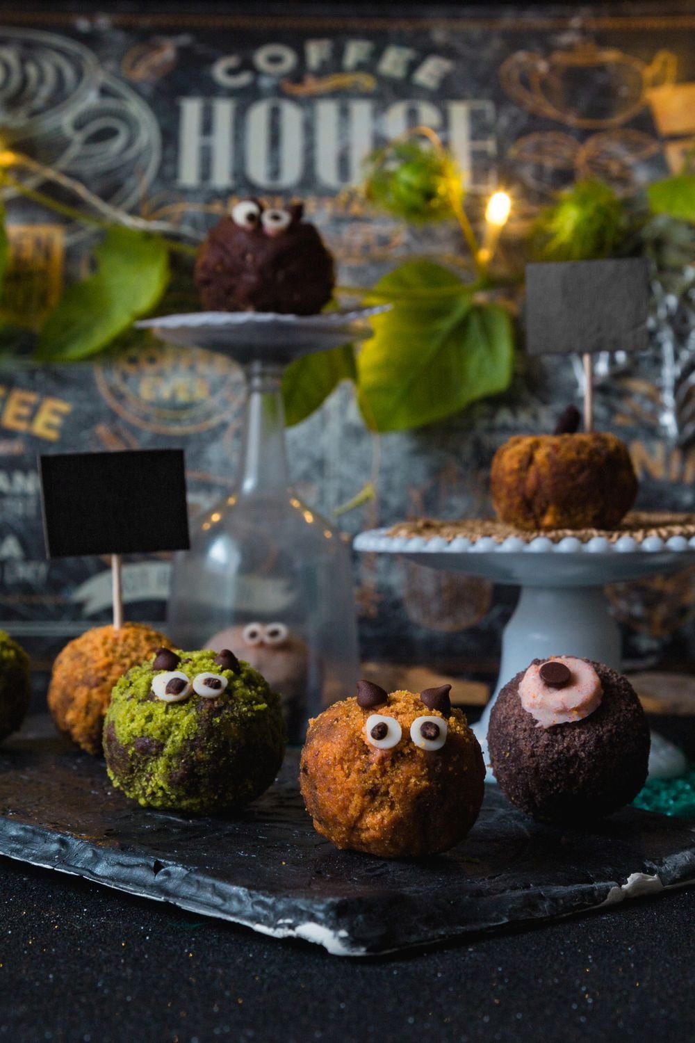 Spooky Eyeball Oreo Cookie Balls (The No-Bake 20-Minute Halloween Treat) 5 Spooky eyeball Oreo balls displayed on a coffee-house stand with green and orange monsters