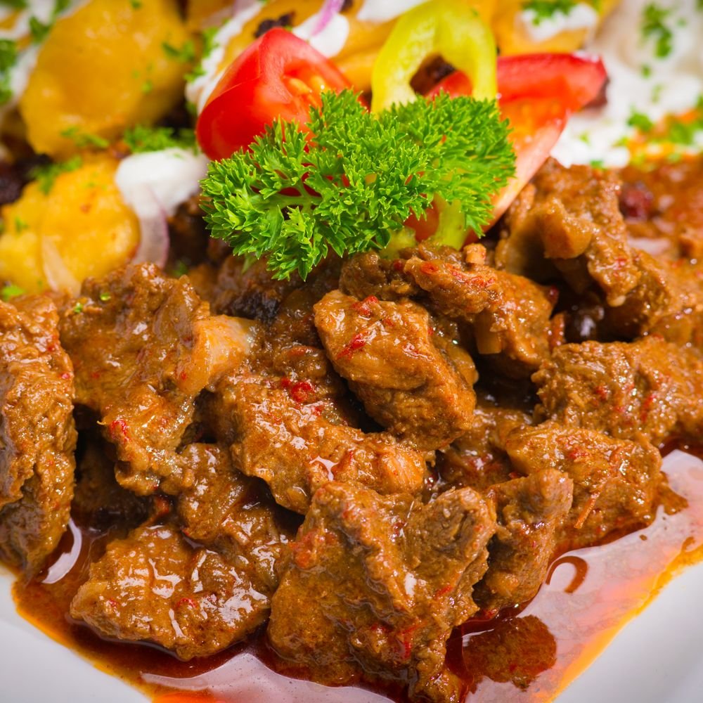 Ghoul-ash (The Spooky 45-Minute Halloween Beef Goulash) 3 Overhead bowl of beef goulash with beef chunks and potatoes in orange-red paprika broth