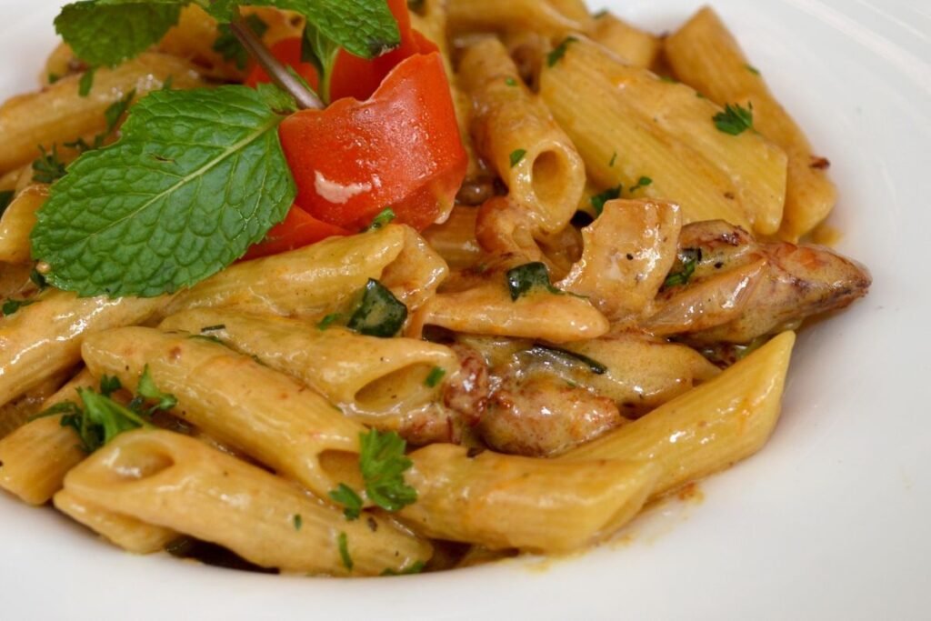 Creamy Marry Me Chicken Pasta (The 30-Minute Weeknight Dinner) 6 Close-up of creamy penne with tender chicken in sun-dried tomato Parmesan sauce