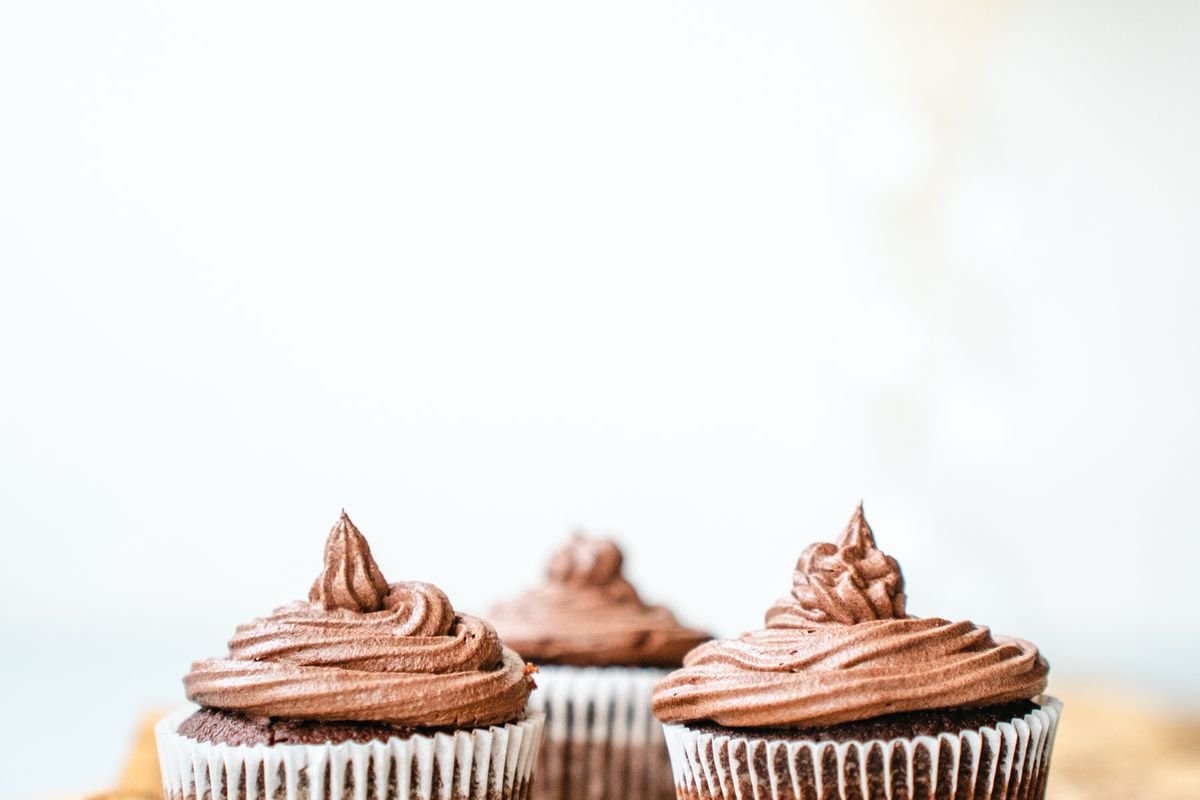 Death by Chocolate Cupcakes (The Ultra-Fudgy 40-Minute Triple-Chocolate Recipe) 6 Three chocolate frosted cupcakes on a white background