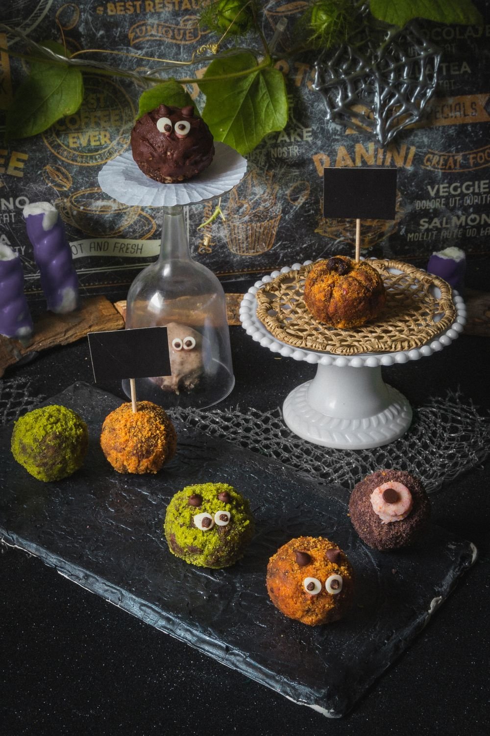 Spooky Eyeball Oreo Cookie Balls (The No-Bake 20-Minute Halloween Treat) 6 Halloween Oreo eyeball balls on a slate board with purple candles and cobweb decor
