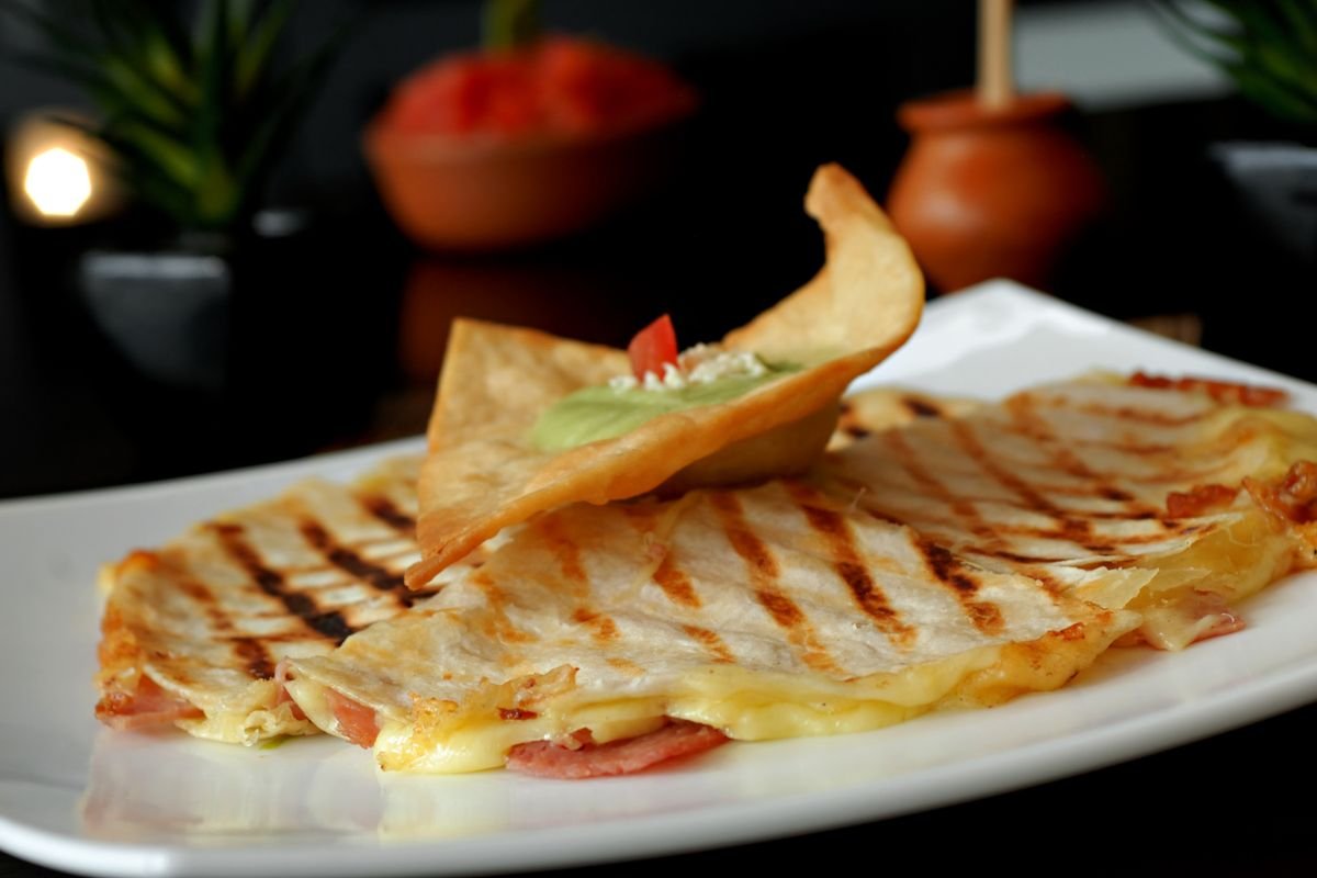 Jack-o'-Lantern Quesadillas (The Spooky 25-Minute Halloween Quesadillas) 6 Sliced jack-o'-lantern quesadilla wedges served warm with salsa