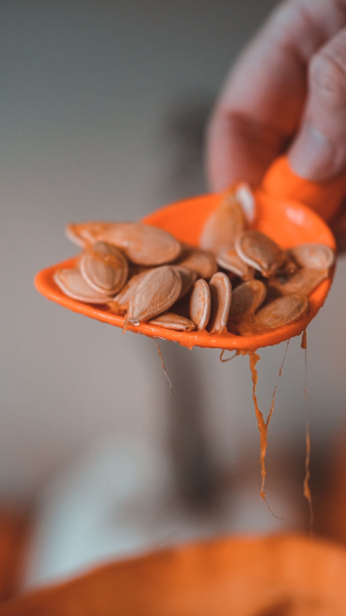 Air Fryer Roasted Pumpkin Seeds (3 Flavors — The Crunchy 20-Minute Halloween Snack) 3 Scooping seeds from a carved pumpkin