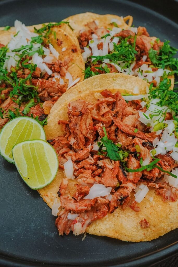 Spiderweb Tacos (The Spooky 20-Minute Halloween Taco Night) 4 Al pastor style tacos topped with cilantro and onion, lime wedges on the side