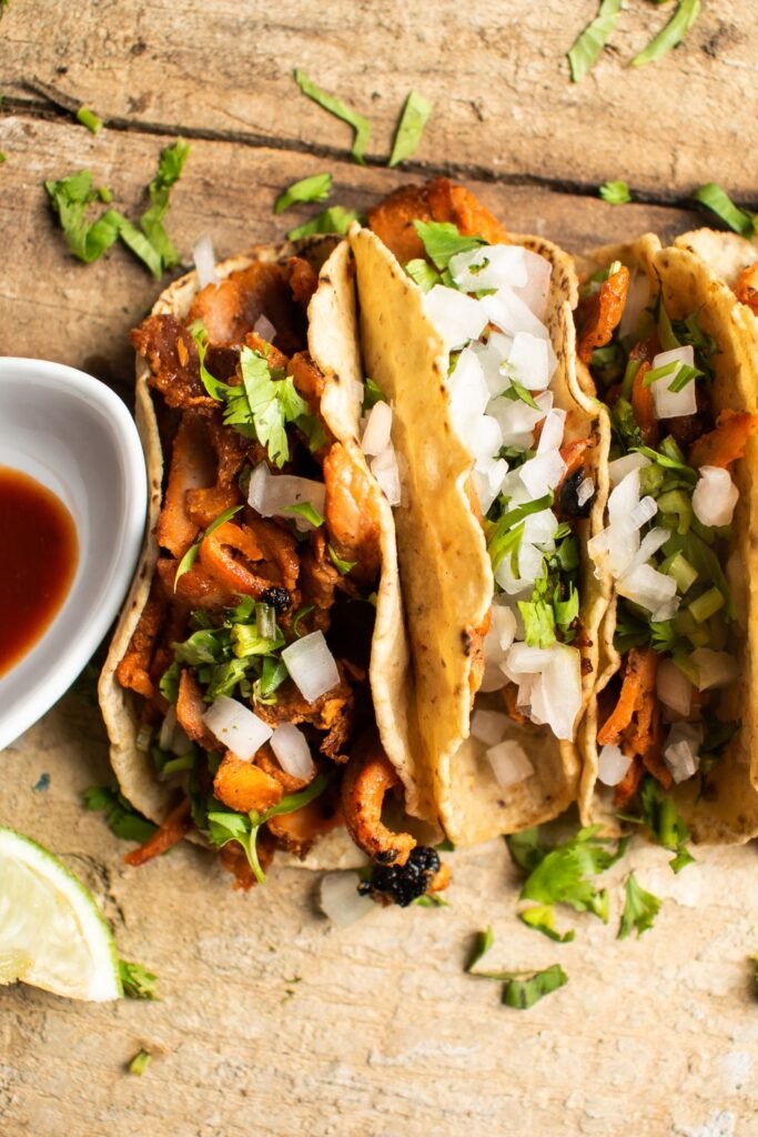 Spiderweb Tacos (The Spooky 20-Minute Halloween Taco Night) 6 Shredded beef tacos with cabbage and fresh herbs on a wooden board