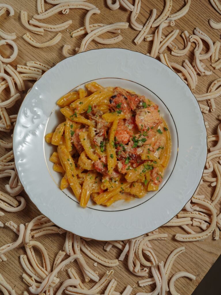 Creamy Pumpkin Pasta (The Cozy 25-Minute Fall Pasta) 6 Plate of orange pumpkin penne with Parmesan from above