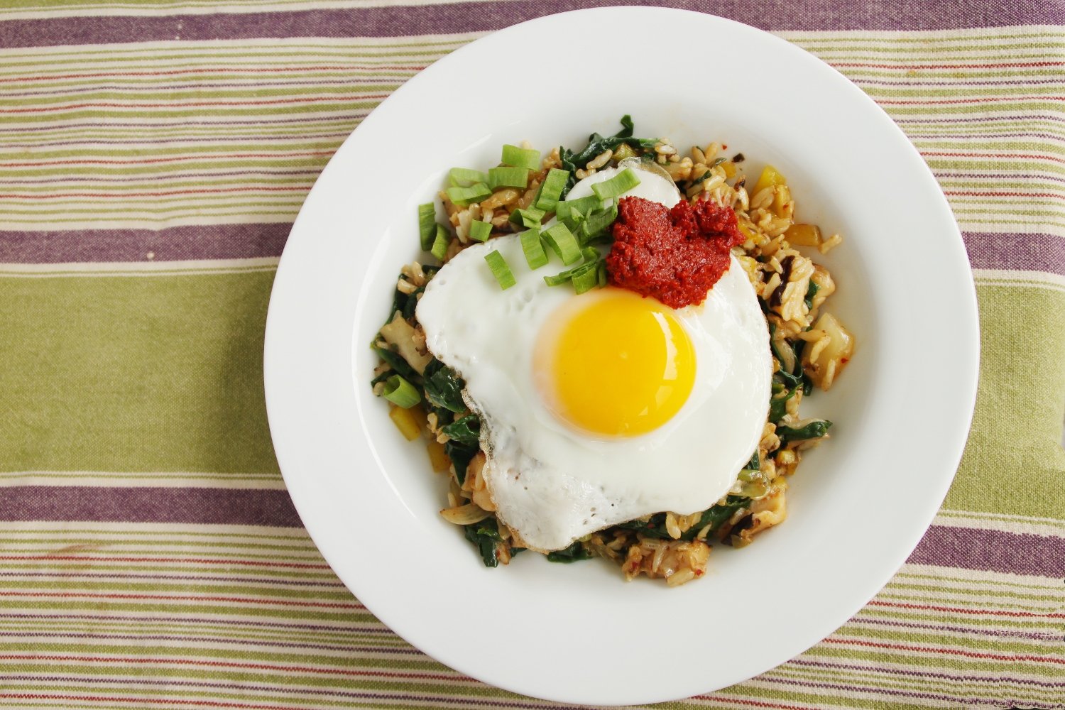Kimchi Fried Rice (Kimchi Bokkeumbap, 25 Minutes) 3 Kimchi fried rice with leafy greens and chili paste on a fried egg