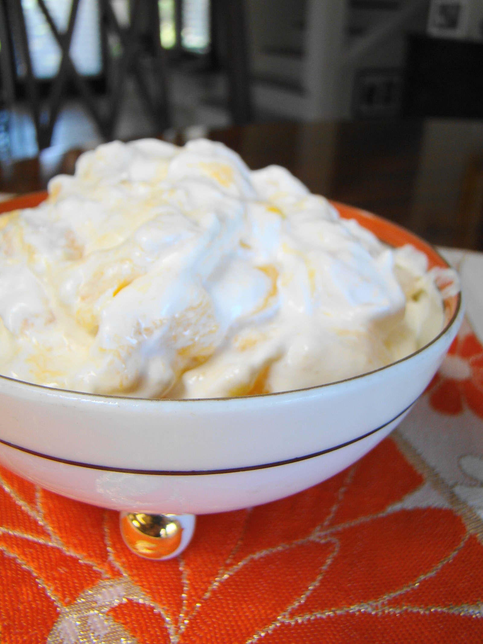 A bowl of mango mousse with mango swirls