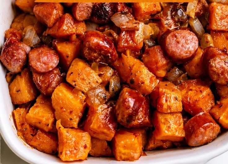 One-pan sausage and sweet potato bake with caramelized onion pieces