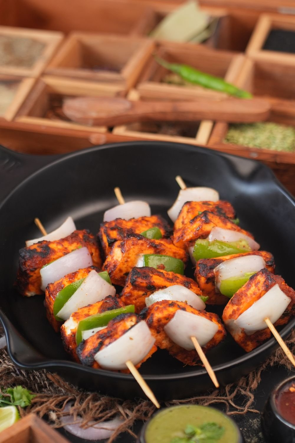 Grilled paneer tikka served with chutneys and spices