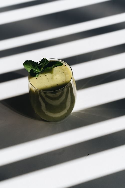 Pale-green creamy monster shake with a mint leaf