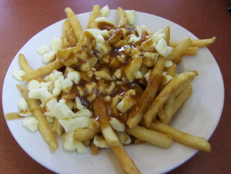 Classic poutine: crispy golden fries topped with white cheese curds and glossy brown gravy