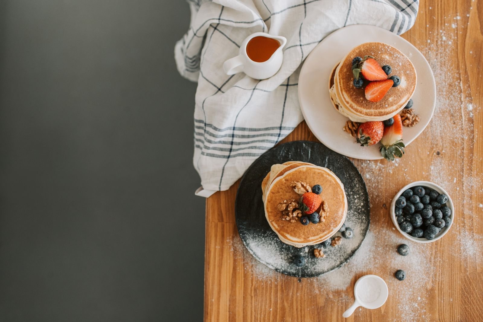 Protein Pancakes (Thick, Fluffy, and Seriously Filling) 3 Flatlay of two protein pancake stacks with berries and a syrup jug