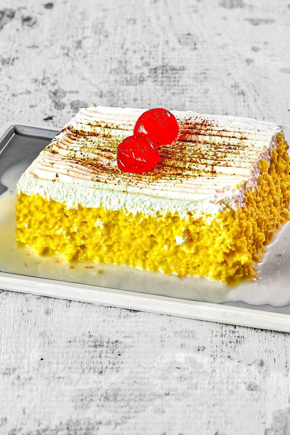 Rose Pistachio Tres Leches (Floral Milk-Soaked Cake With Whipped Cream, Ready in 5 Hours) 3 Tres leches cake with whipped cream topping dusted with cinnamon and cherries