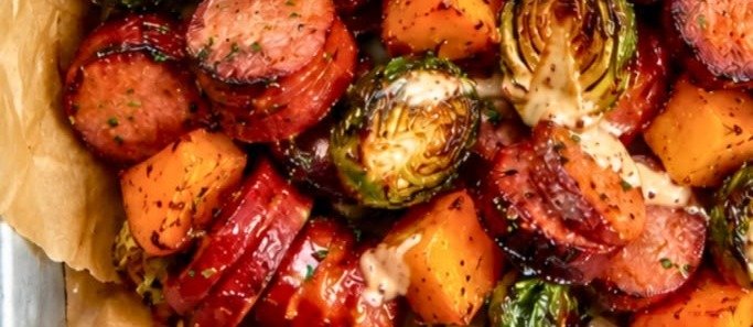 Sheet pan sausage with roasted Brussels sprouts and butternut squash drizzled with apple cider Dijon sauce