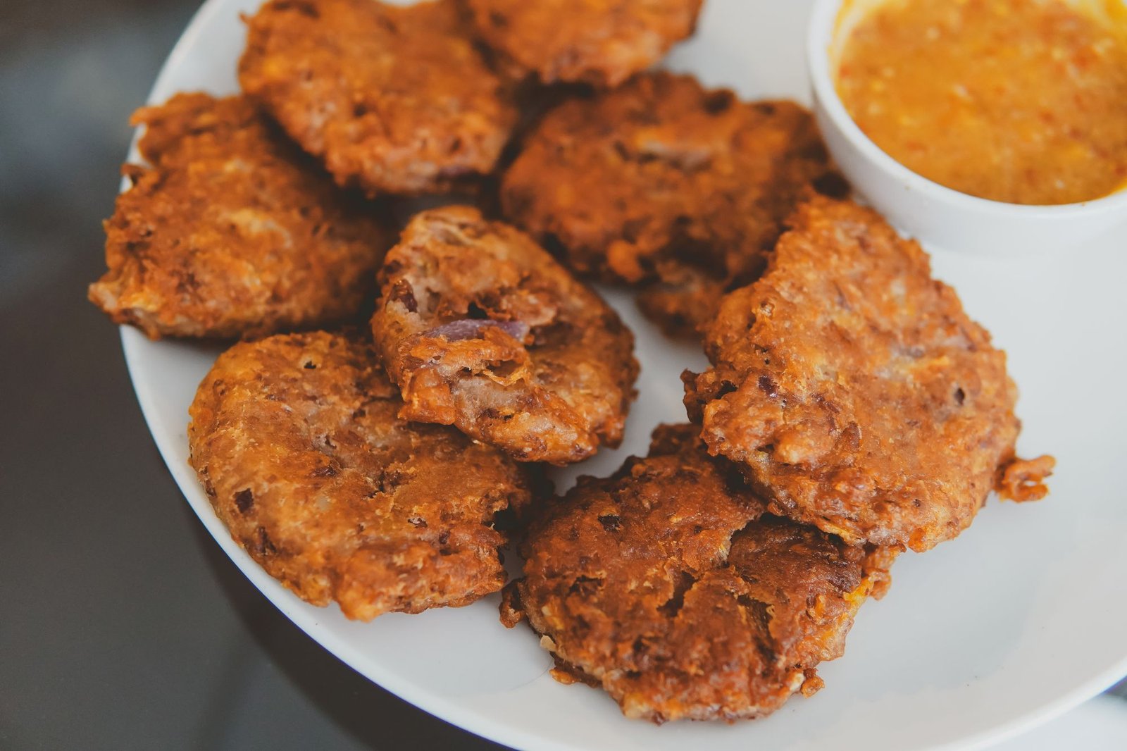 Air Fryer Pumpkin Fritters (The Crispy 25-Minute Halloween Party Snack) 4 Overhead spread of golden pumpkin fritters with dipping sauce