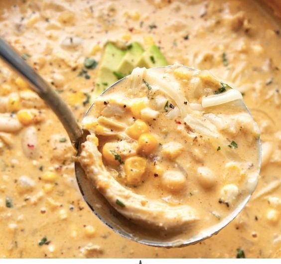 White Chicken Chili 3 Ladle lifting a scoop of creamy white chicken chili from the pot